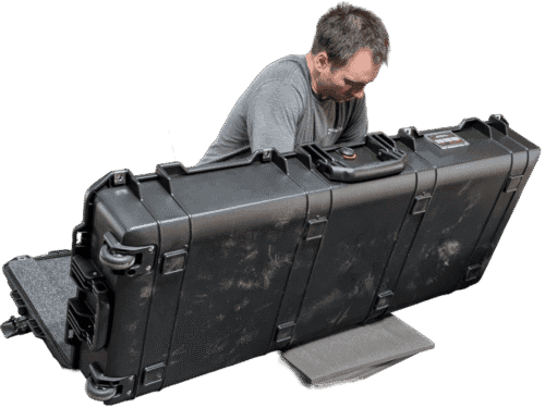 Foam being installed in the lid of a long open hard case.