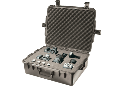 Open tan hard case with cameras, lenses and accessories held in foam