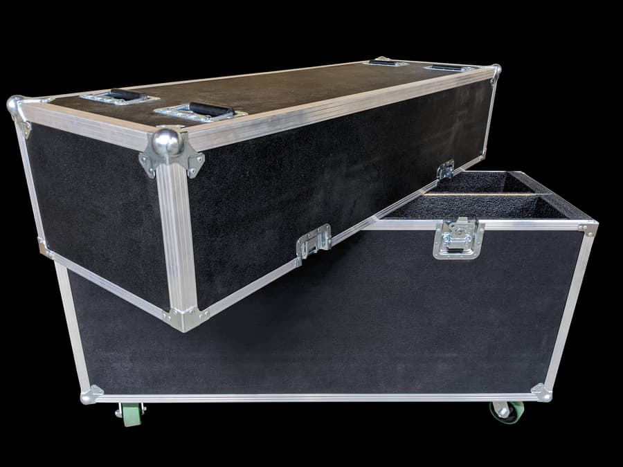 Long black ATA case with foam dividers and a detached panel.