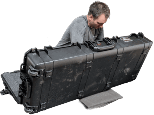 Foam being installed in the lid of a long open hard case.
