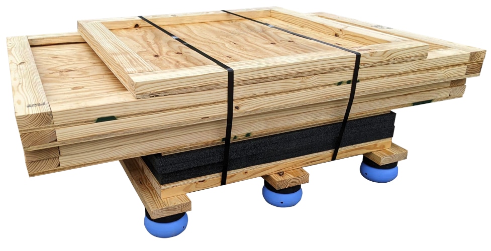 Wooden crate panels strapped onto a base with blue supports beneath it.