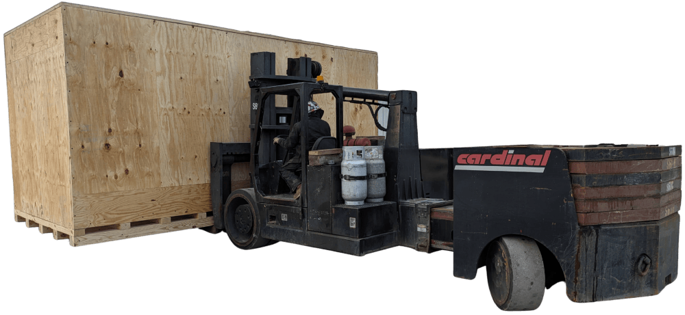 Forklift beside a large wooden crate.