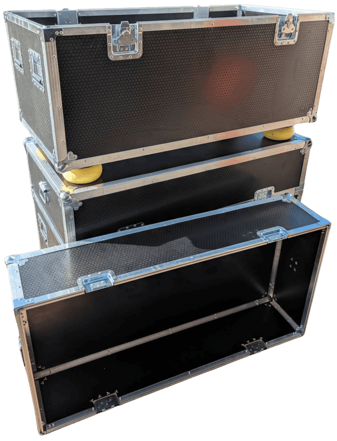 Two black cases stacked together, with an open front and internal shelf visible.