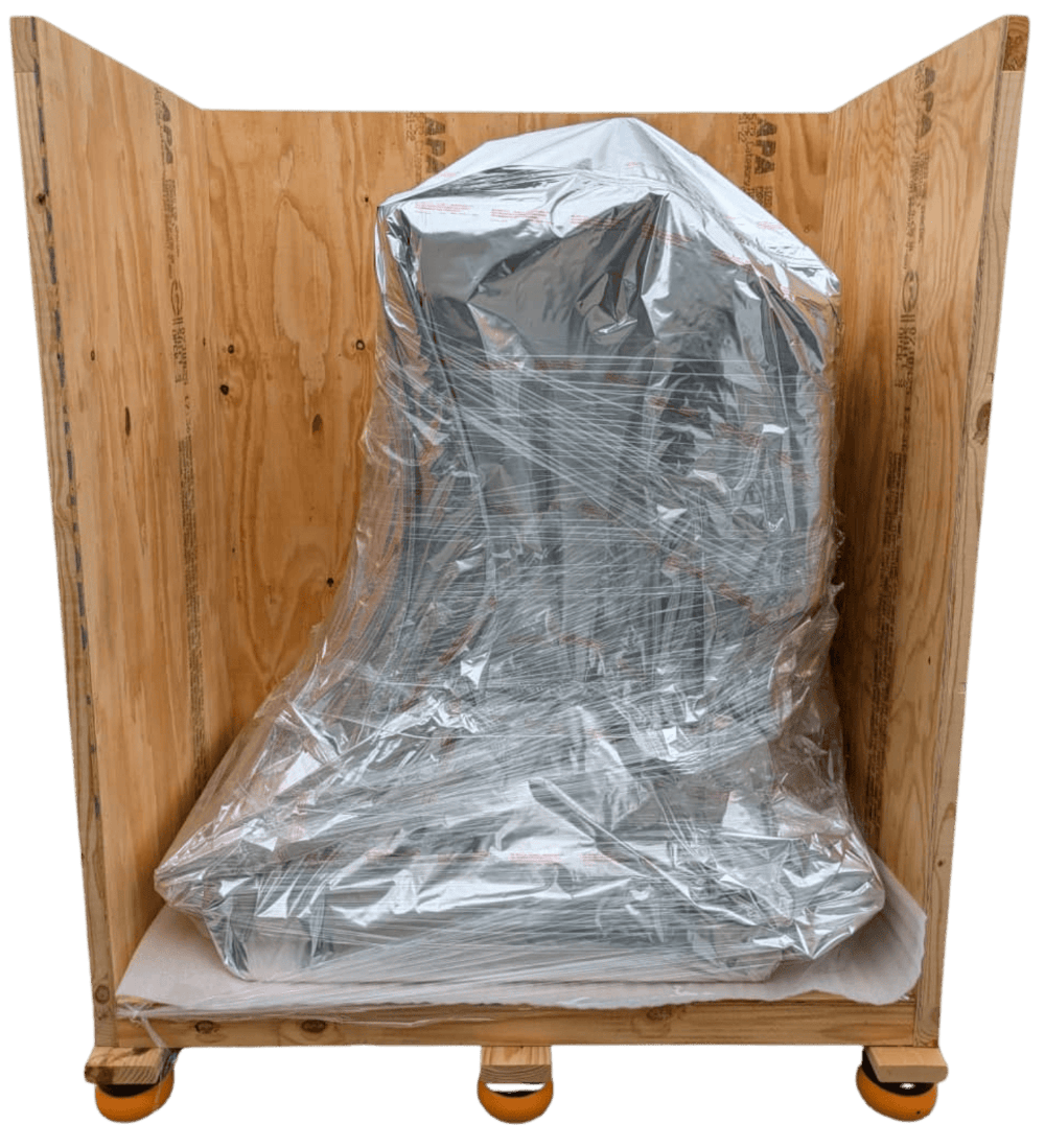 Partially enclosed wooden crate containing a load wrapped in reflective barrier material.