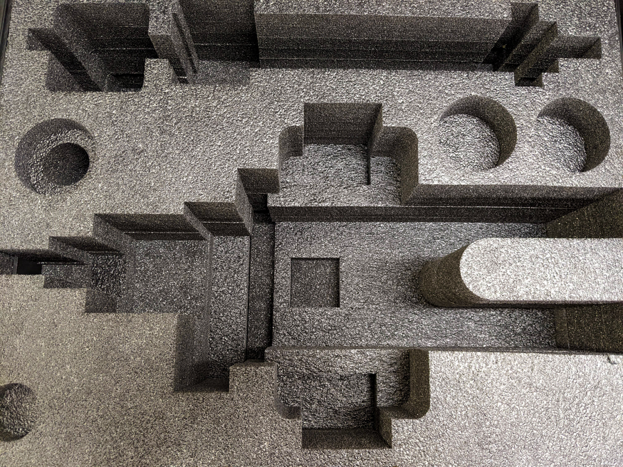 Close-up of shaped foam pockets with circular and rectangular openings.