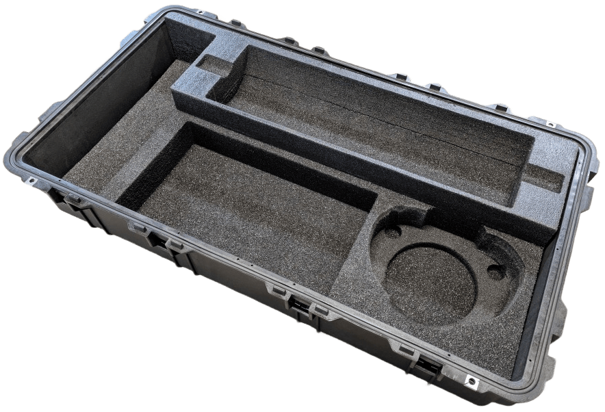 Hard-case base with deep rectangular foam pockets and a circular recess.