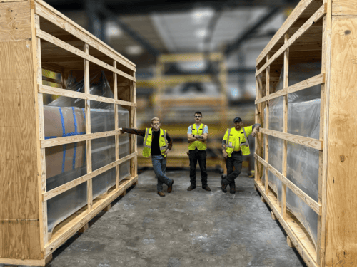 Team picture with two large slat crates